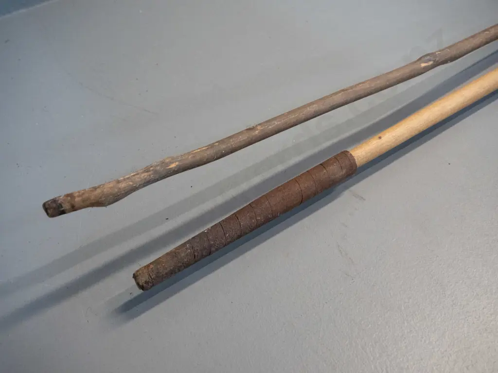 2 vintage spears with timber shafts and forged iron heads, one with skin grip and forged metal tail binding has broken Image 1++