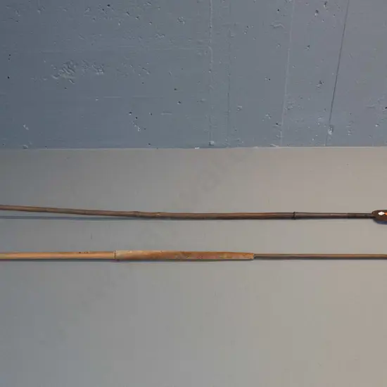 2 vintage spears with timber shafts and forged iron heads, one with skin grip and forged metal tail binding has broken