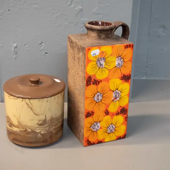 2 pieces of studio pottery - Te Rona lidded pot and a retro slab sided rough textured jug vase with one glazed floral