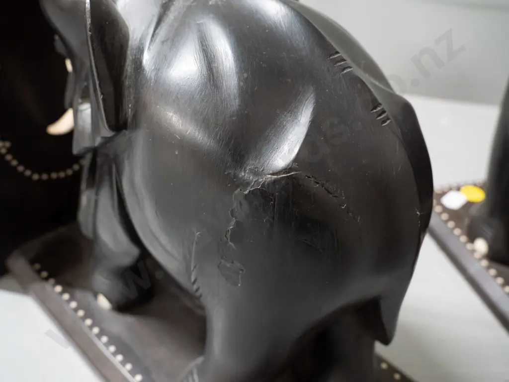 pair of ebony elephant book ends with shallow inlay dot pattern decoration, marked Sri Lanka - some chips and repaired Image 1++