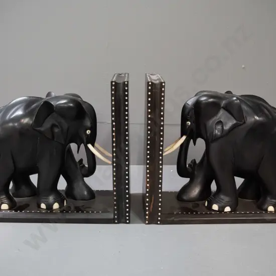 pair of ebony elephant book ends with shallow inlay dot pattern decoration, marked Sri Lanka - some chips and repaired