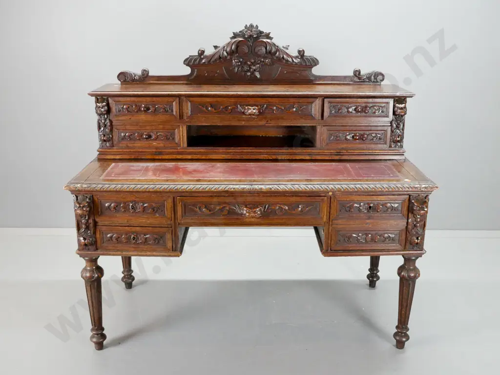 1870s European dark stained oak desk w/ carved crest and drawer fronts, pull-out top with 3 tooled Image 1++