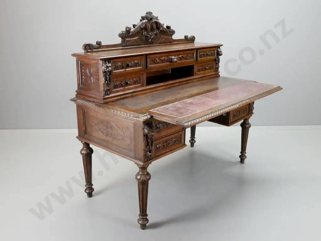 1870s European dark stained oak desk w/ carved crest and drawer fronts, pull-out top with 3 tooled Image 1++