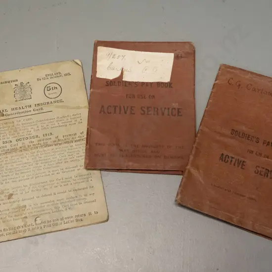 two first world war vintage New Zealand soldiers pay books and a 1913 National Health Insurance coupon book