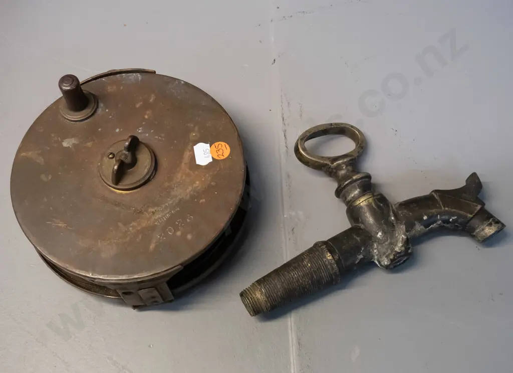 vintage brass and steel measuring tape with leather strap, marked W. Littlejohn & Son Wellington and a cast brass tap Image 1++