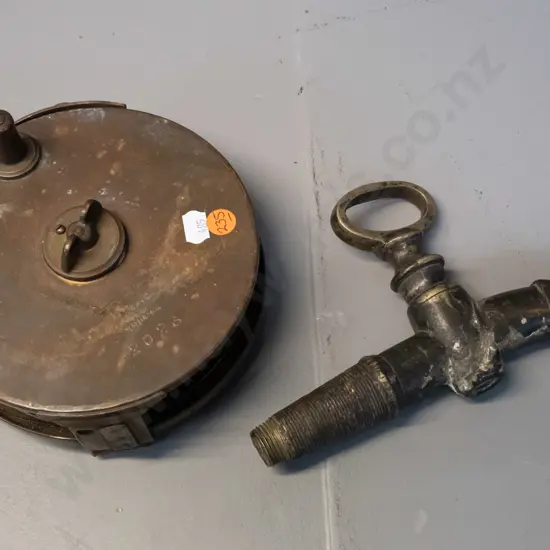 vintage brass and steel measuring tape with leather strap, marked W. Littlejohn & Son Wellington and a cast brass tap