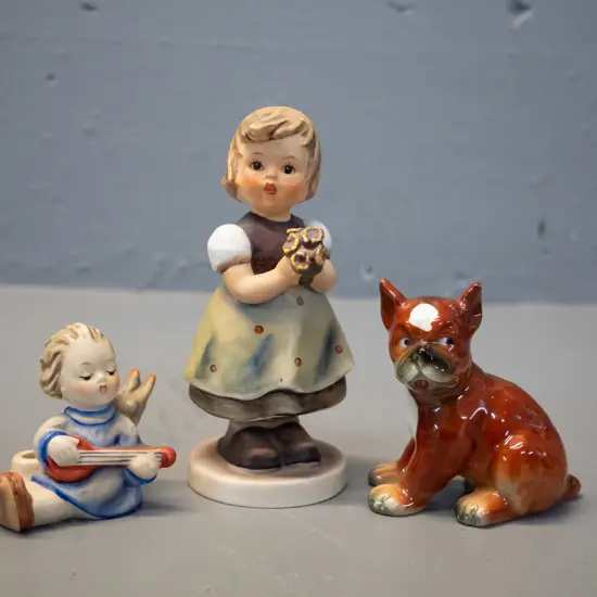 3 Goebels figurines - girl with posie H-130, angel with stringed instrument and high glaze boxer puppy