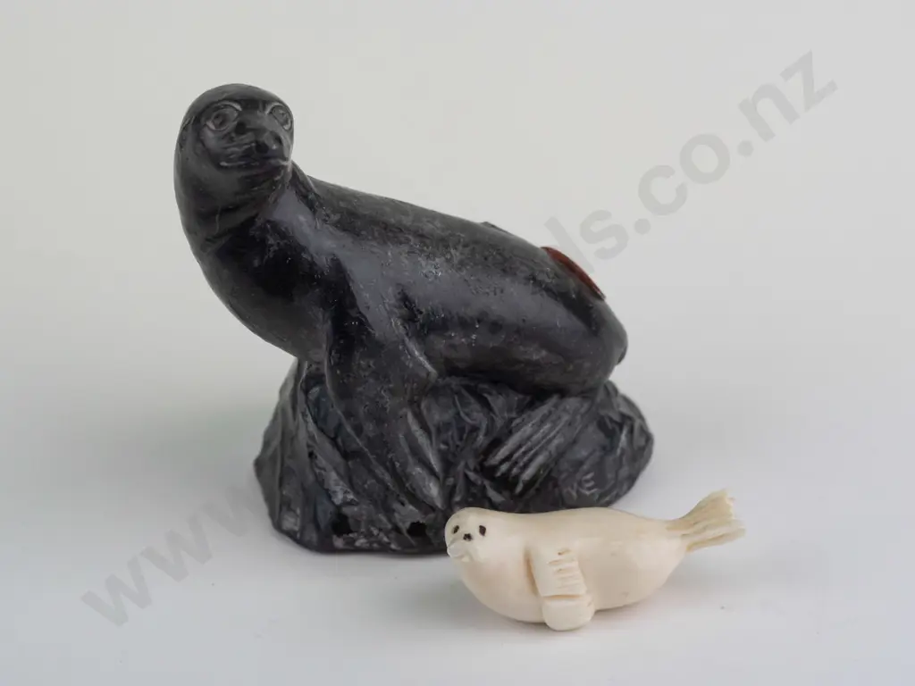 small carved bone? seal figure marked Robert Apatiki on base, and a carved black soapstone seal made in Canada H-80 Image 1++