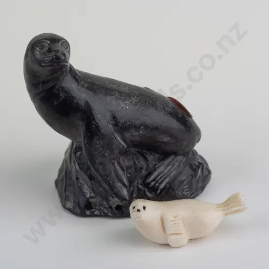 small carved bone? seal figure marked Robert Apatiki on base, and a carved black soapstone seal made in Canada H-80