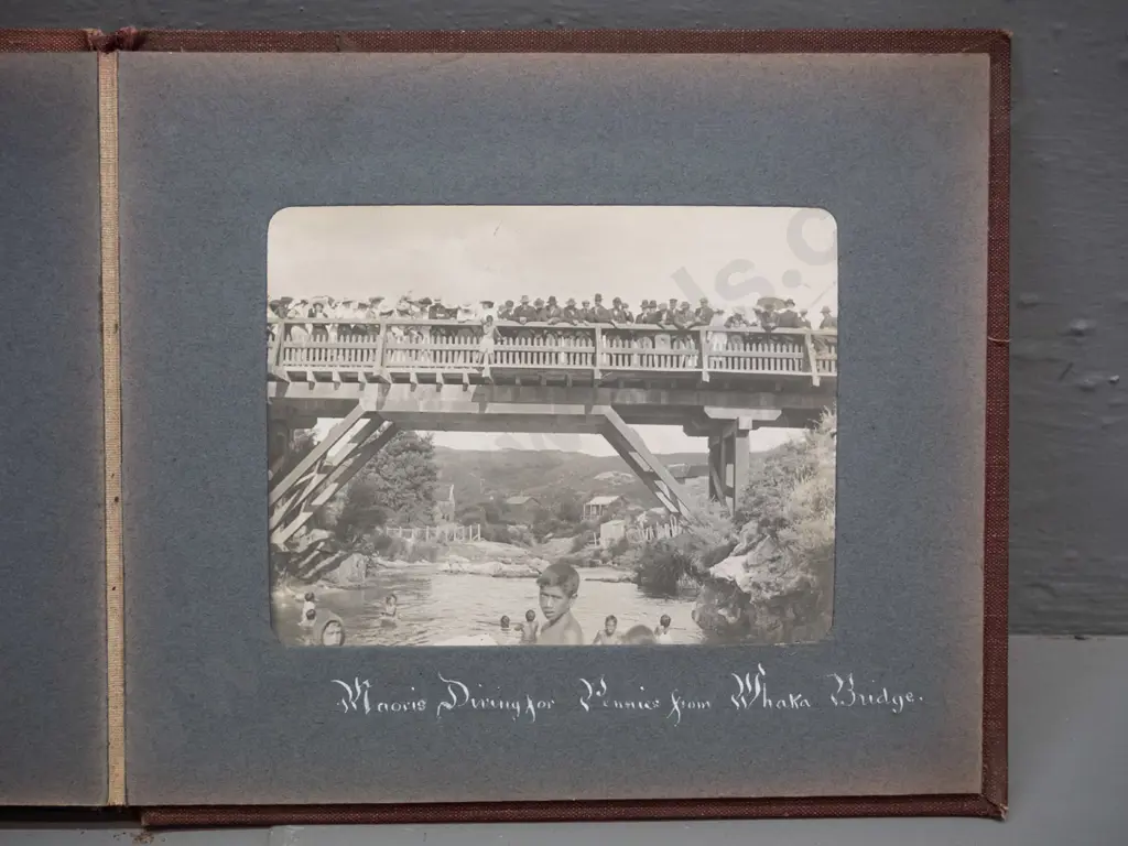 small vintage photograph album with mainly Rotorua tourist subjects, Lake Rotokakha, diving at Whaka Bridge, etc. Image 1++