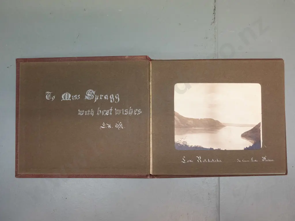 small vintage photograph album with mainly Rotorua tourist subjects, Lake Rotokakha, diving at Whaka Bridge, etc. Image 1++