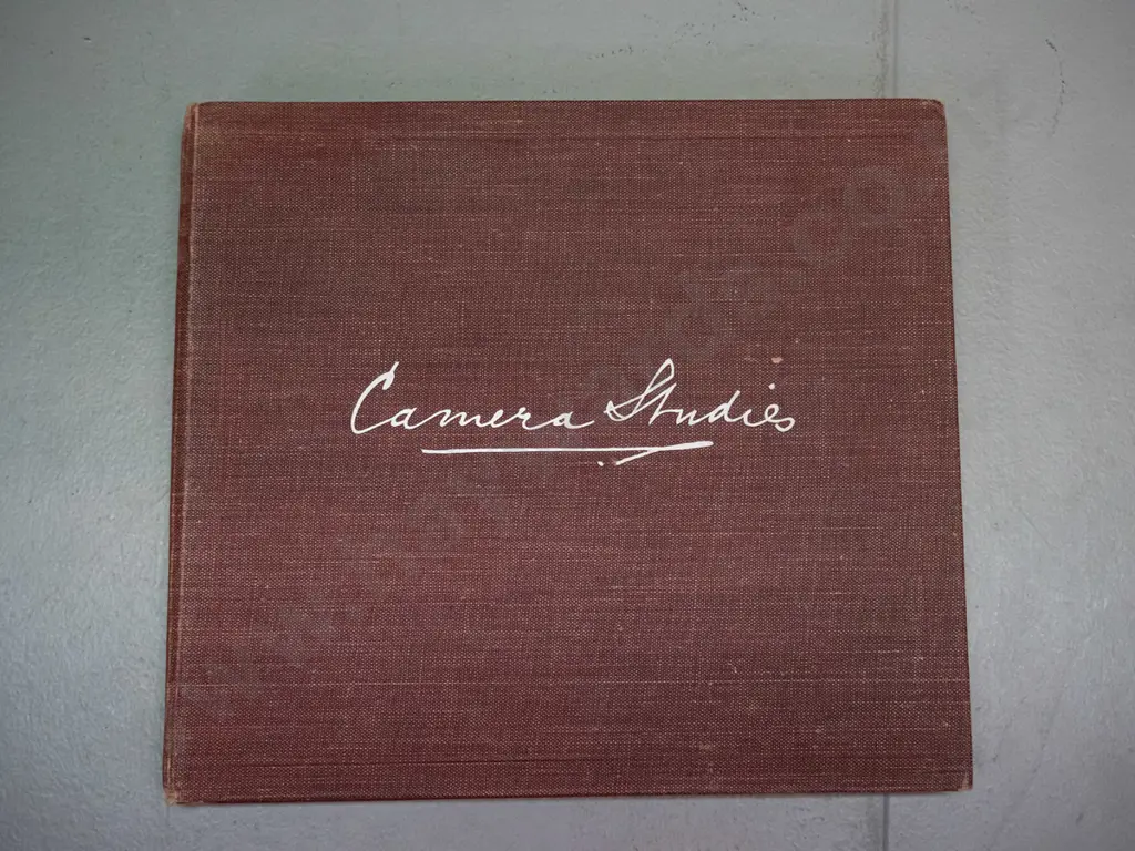 small vintage photograph album with mainly Rotorua tourist subjects, Lake Rotokakha, diving at Whaka Bridge, etc. Image 1++