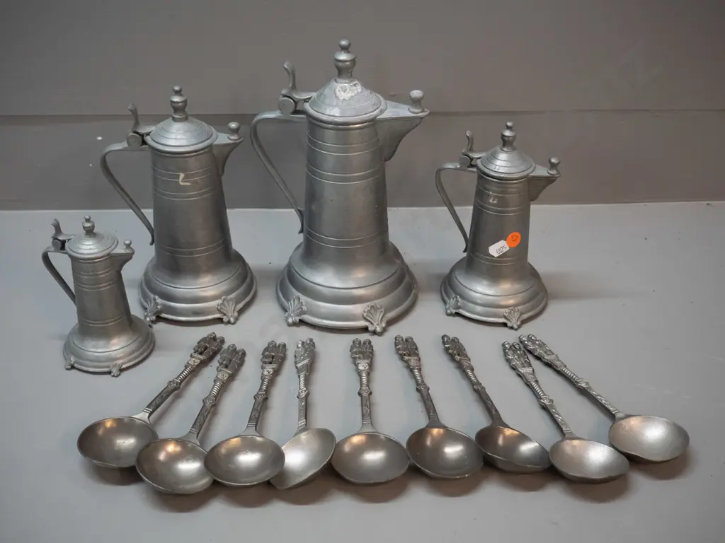 German pewter ware - 4 graduated jugs / coffee pots and 9 soup spoons with figural handles; some wear and marks. Tallest Image 1++