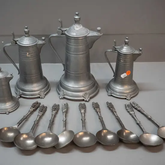 German pewter ware - 4 graduated jugs / coffee pots and 9 soup spoons with figural handles; some wear and marks. Tallest