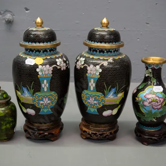 Chinese cloisonne ware - pair of black lidded temple jars on carved timber stands, small vase on stand, and small green
