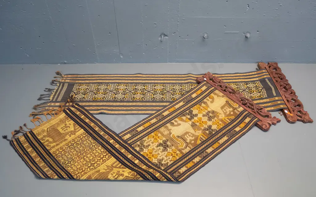 2 Indonesian (Tenun Ikat) woven fabric wall hangings on carved timber hangers - some fraying and wear, fading, one has a Image 1++