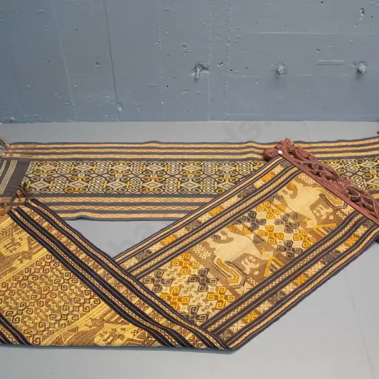 2 Indonesian (Tenun Ikat) woven fabric wall hangings on carved timber hangers - some fraying and wear, fading, one has a