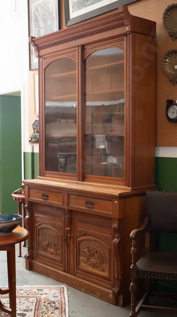 colonial rimu sideboard with bookcase top, 2 glazed sliding doors, 2 drawers with brass handles over 2 panelled cupboard Image 1++