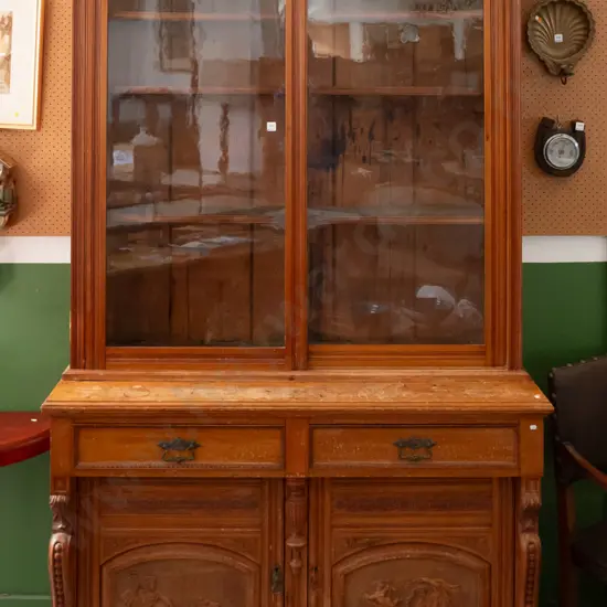 colonial rimu sideboard with bookcase top, 2 glazed sliding doors, 2 drawers with brass handles over 2 panelled cupboard