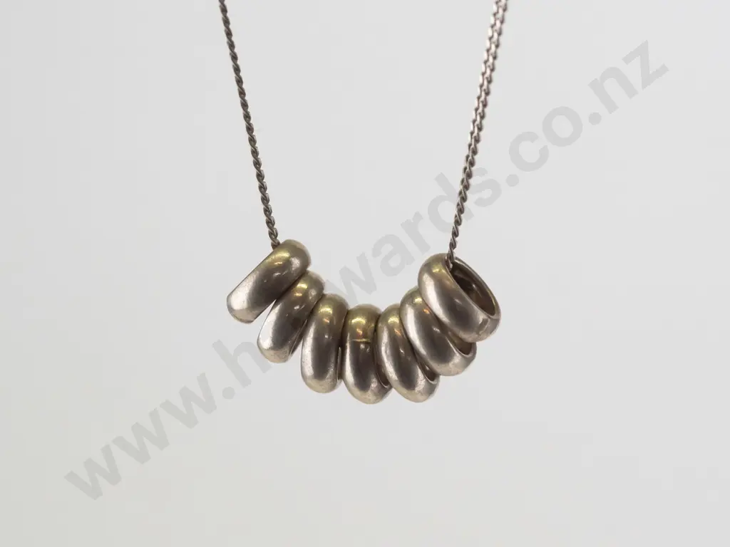 silver necklace with 7 small rings stamped 925 Image 1++