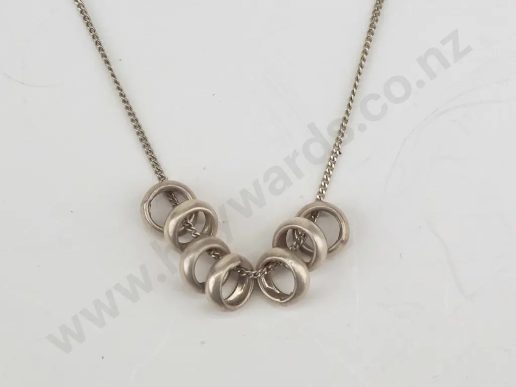 silver necklace with 7 small rings stamped 925 Image 1++