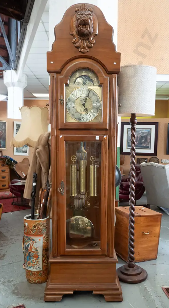 German large long-cased clock with /carved lion's head on shield top, arched glass door, 2 glazed doors to top, brass Image 1++