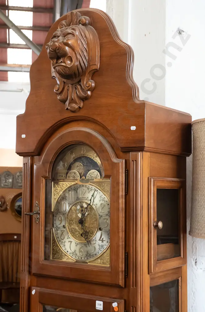 German large long-cased clock with /carved lion's head on shield top, arched glass door, 2 glazed doors to top, brass Image 1++