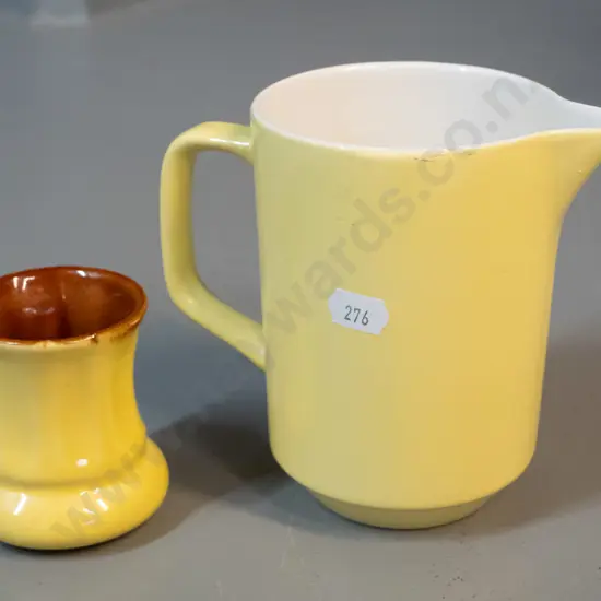 2 Crown Lynn yellow glaze items - small vase with brown interior and a milk jug with white interior with faint Made in