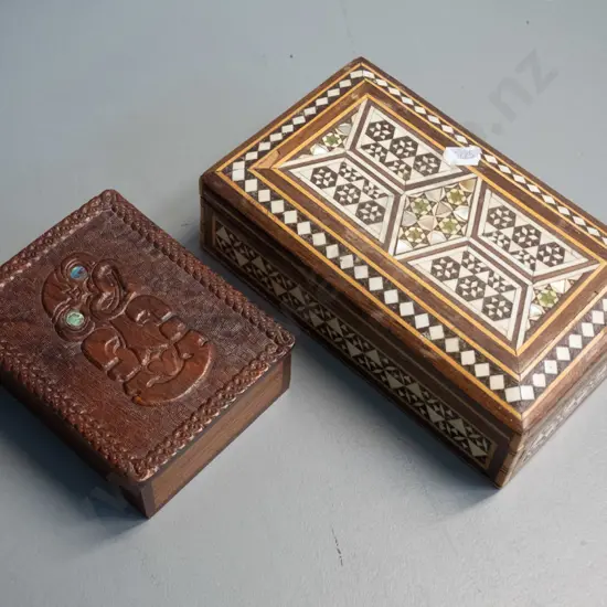 carved Maori motif timber lidded box with paua inset eyes and a middle eastern inlay jewellery box in restorer's