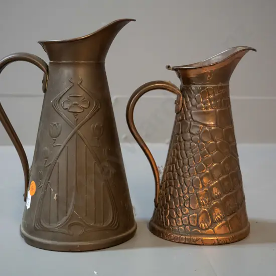 2 deco style copper jugs marked JS&S England "Solid Copper" - larger deco style H-210, smaller crocodile skin pattern