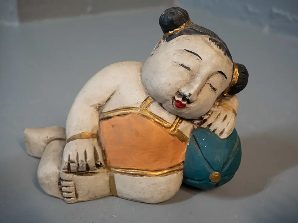 3 Asian figurines - composite seated Buddha H-115, composite sow and piglets, and a painted timber reclining figure Image 1++