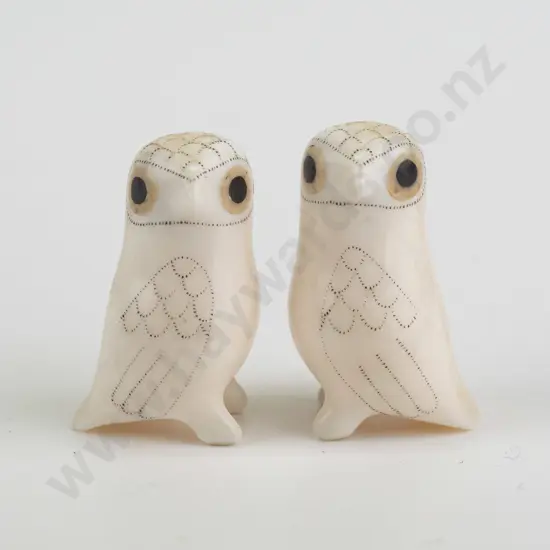 2 small carved bone? arctic owl figures with scrimshaw style feather designs, both marked Don Ungott on base. H-35