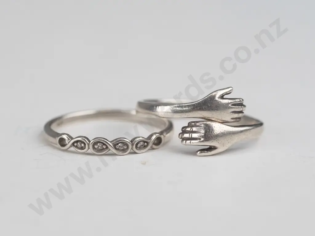 silver ring hands crossover [slighly out of shape] & silver cz ring both stamped 925 Image 1++