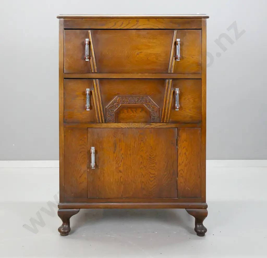 art deco oak cabinet with 2 drawers, single cupboard door with applied decoration, chrome and bakelite handles, on short Image 1++
