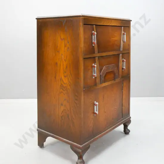 art deco oak cabinet with 2 drawers, single cupboard door with applied decoration, chrome and bakelite handles, on short
