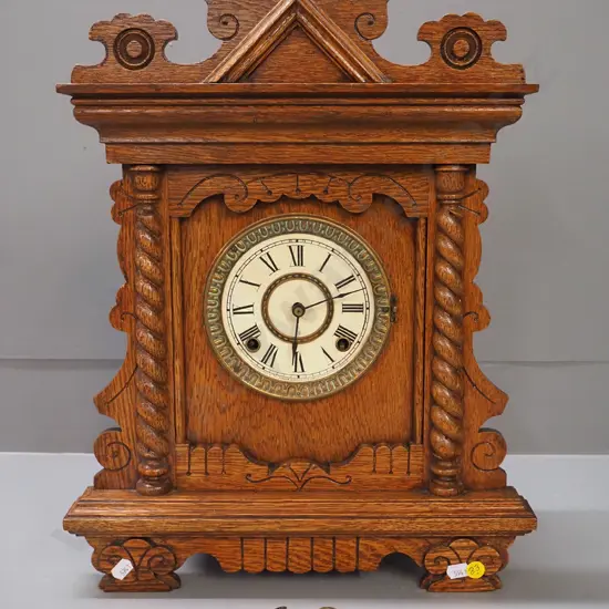 oak cased Ansonia mantel clock with pendulum and key - brass and printed card face, missing glass bezel H480 W360 D125