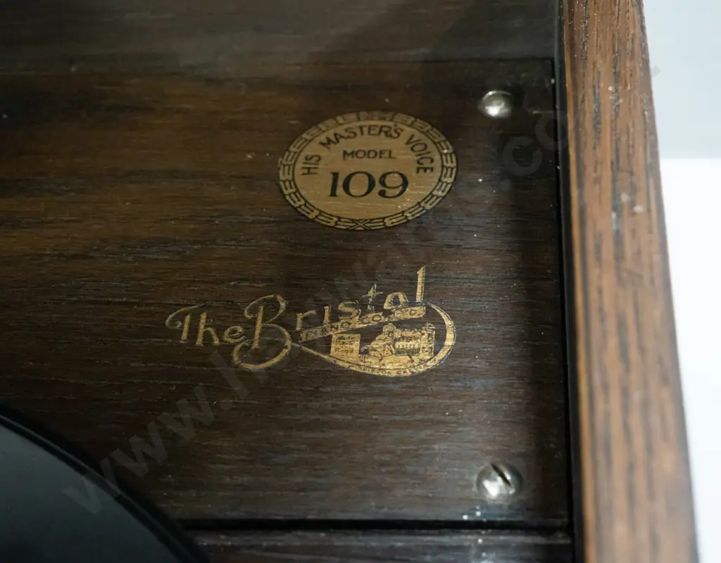 vintage HMV oak-cased wind-up gramophone with Bristol Piano Co. label, 2 tins and sample paper packets of needles, and a Image 1++