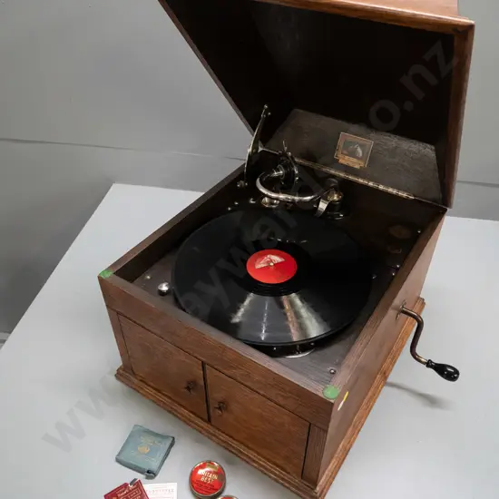 vintage HMV oak-cased wind-up gramophone with Bristol Piano Co. label, 2 tins and sample paper packets of needles, and a