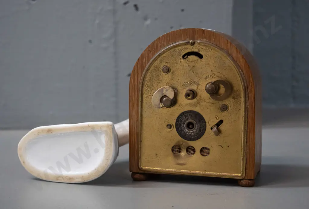 small oak-cased German bedside alarm clock with Dawson's Dunedin markings, and a Crown Lynn bud vase H-170 Image 1++