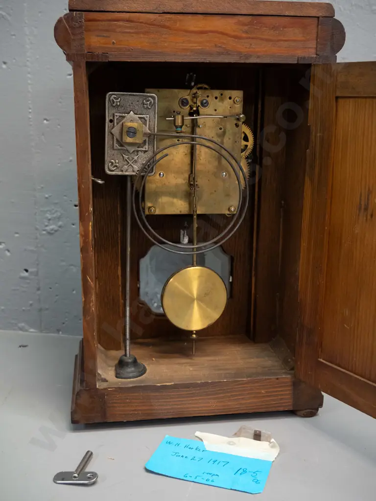 vintage oak cased chiming mantel clock with glazed door, porcelain face, brass bezel and turned columns, missing one Image 1++