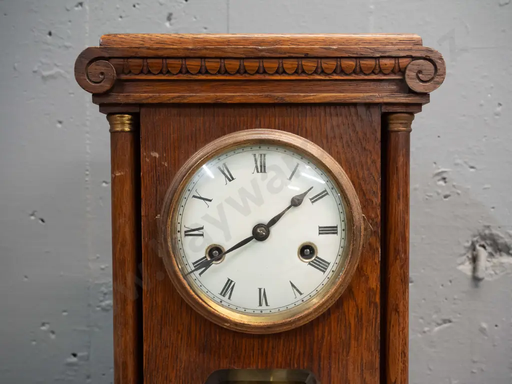 vintage oak cased chiming mantel clock with glazed door, porcelain face, brass bezel and turned columns, missing one Image 1++