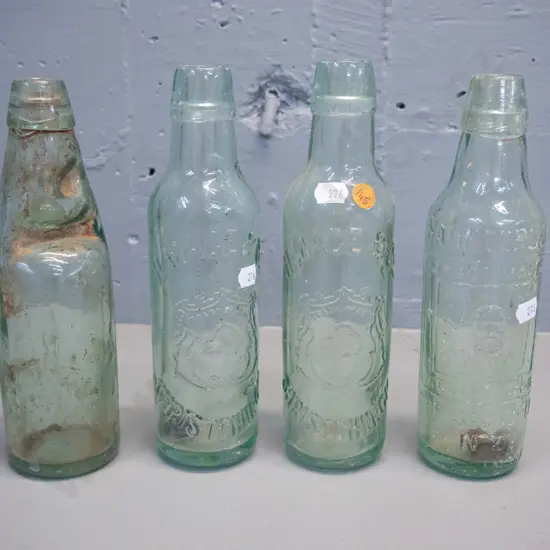 4 vintage glass bottles - two marked H. Mace and Co. Christchurch, Saunders & Co. Christchurch, and an English