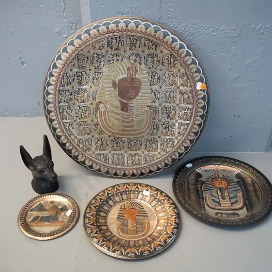 Egyptian souvenir ware - 4 pressed metal wall hangings and a small composite or black stone cat head with small chip to