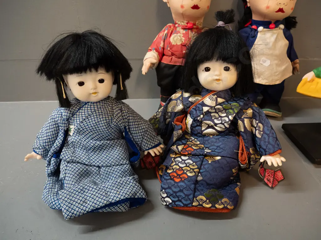 5 asian dolls - large fabric pair marked made in Hong Kong, pair seated porcelain & fabric, and a small ceramic figure Image 1++