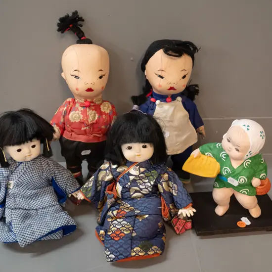 5 asian dolls - large fabric pair marked made in Hong Kong, pair seated porcelain & fabric, and a small ceramic figure
