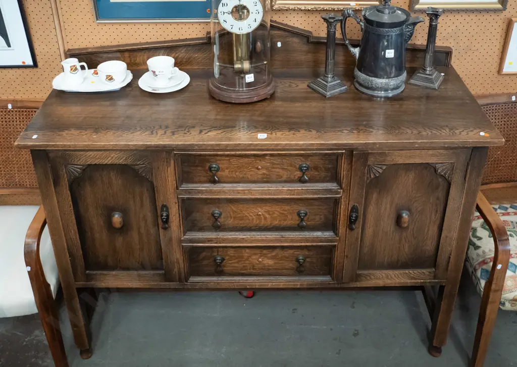 vintage oak Jacobean style sideboard with shaped upstand, 3 central drawer, 2 panelled doors w/fan-shaped corner Image 1++