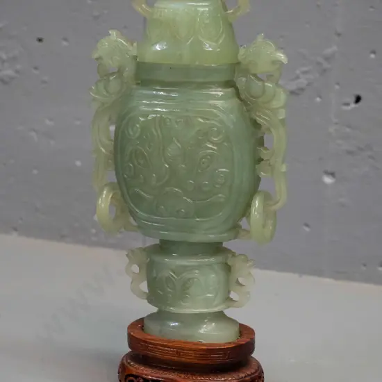 green Chinese jade small lidded urn with ring handles, on carved wooden stand H-230 D-100