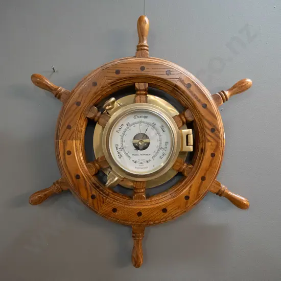reproduction oak ship's wheel and cast brass porthole wall barometer. Marked Royal Mariner, Made in Taiwan sticker D-470