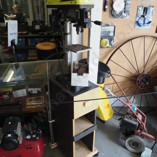 Ryobi 5 speed drill press on homemade stand with box of drill bits and rods