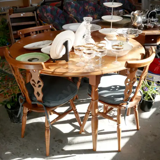 solid wood circular drop side dining table with 4 matching chairs with cushions
